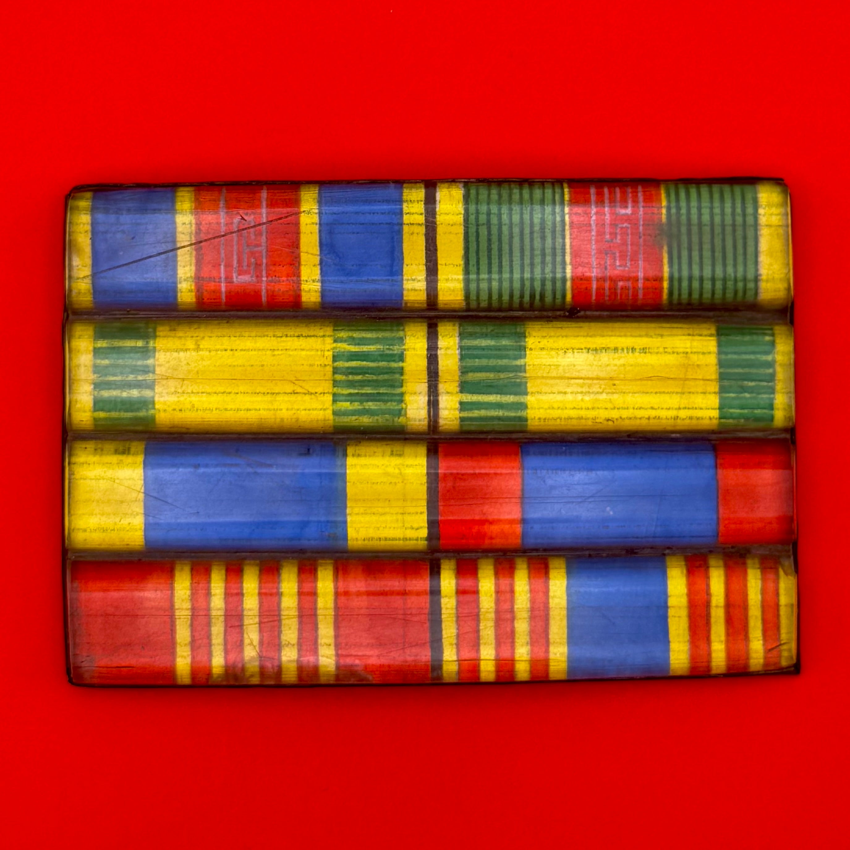 Colorful 1990s Mongolian military ribbon bar in metal frame, representing the transition from socialism to democracy in Mongolia’s armed forces.