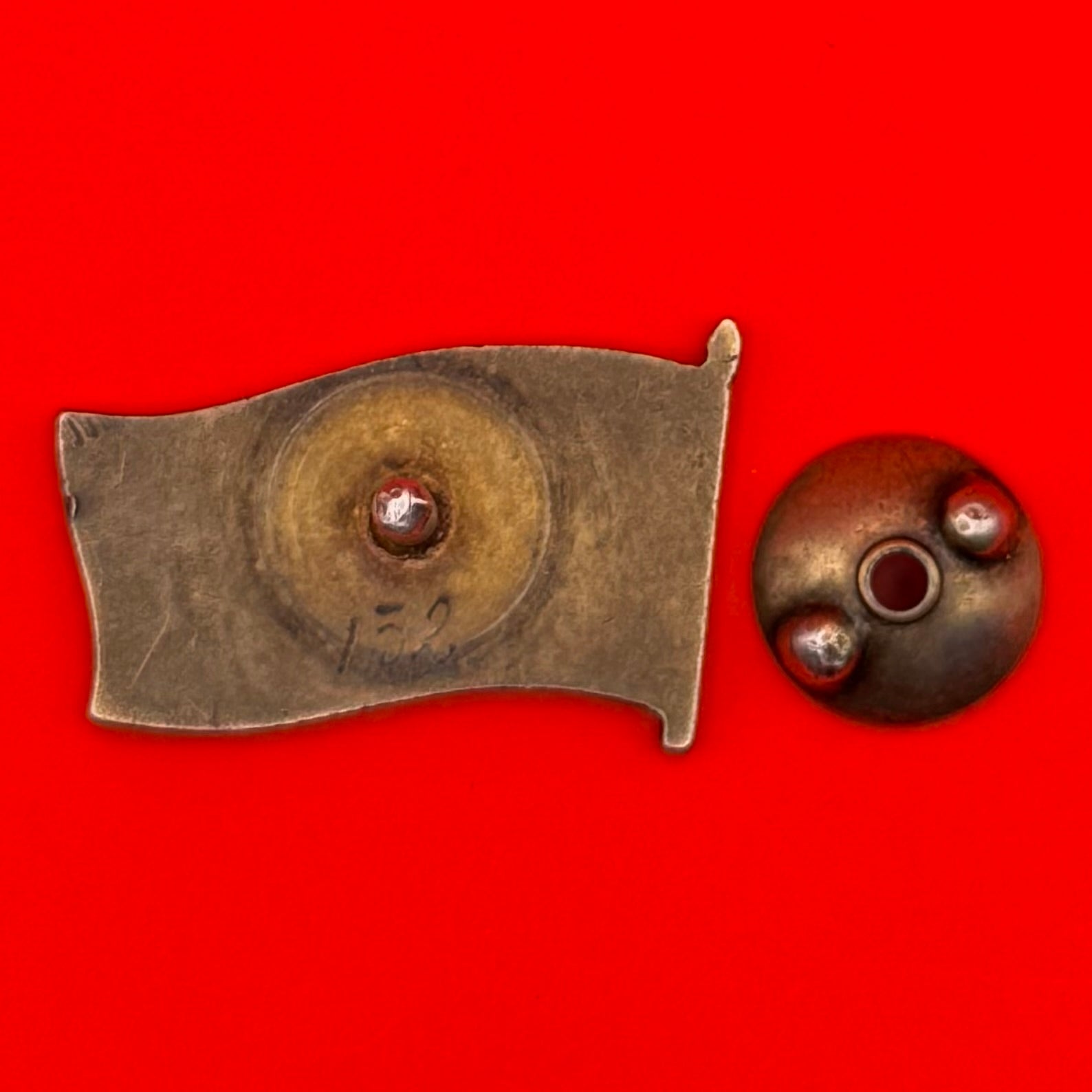 Reverse side of Cold War-era Mongolian deputy badge showing screw-back attachment and maker's detail