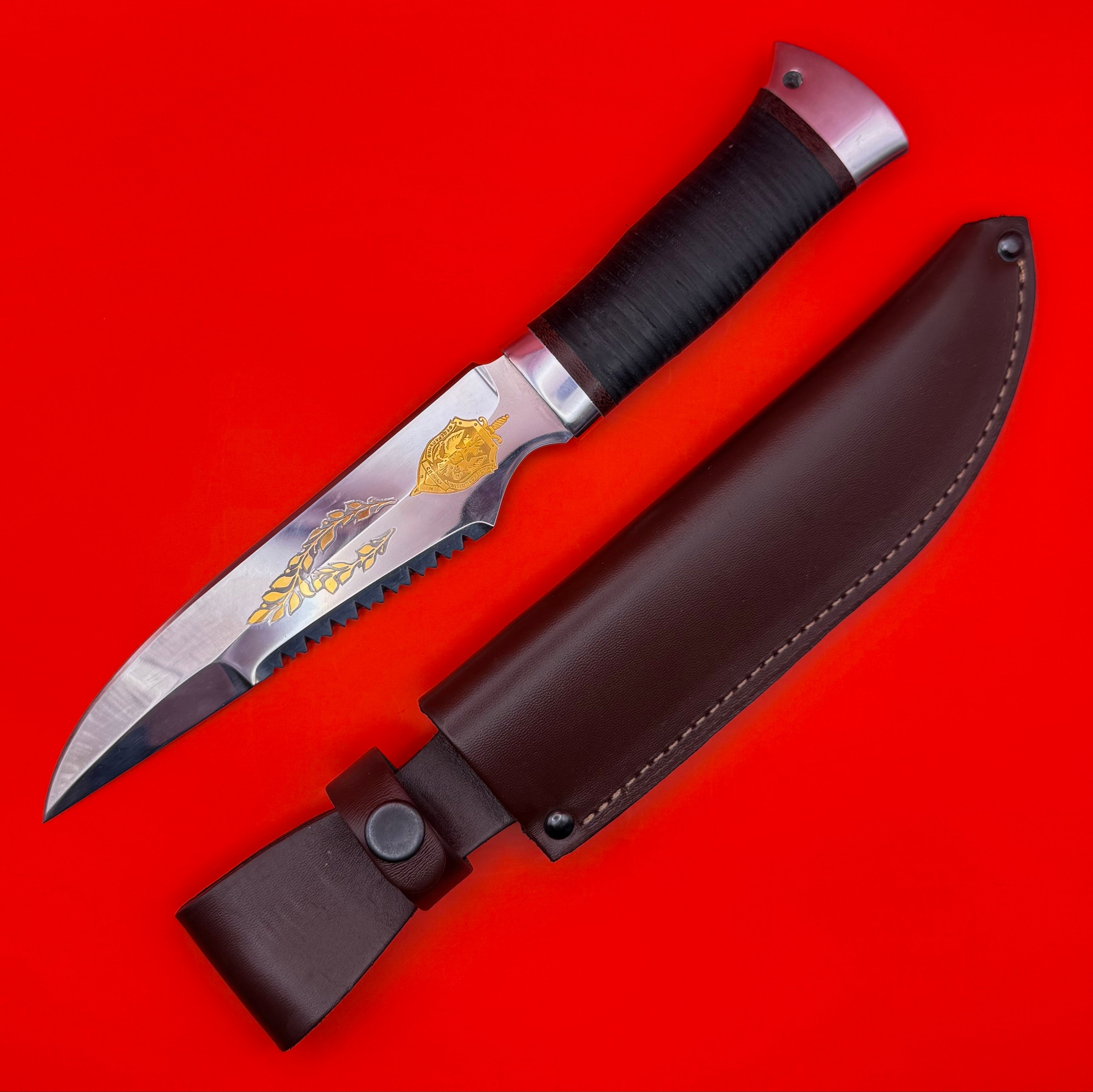Russian FSB General Rank Service Award Knife with 24K gold inlays featuring the official FSB emblem, laurel branches, and honor scrolls. The knife, produced by the renowned Zlatoust arms manufacturer, includes a polished stainless steel blade and a premium leather sheath. A prestigious collectible symbolizing modern intelligence service legacy.