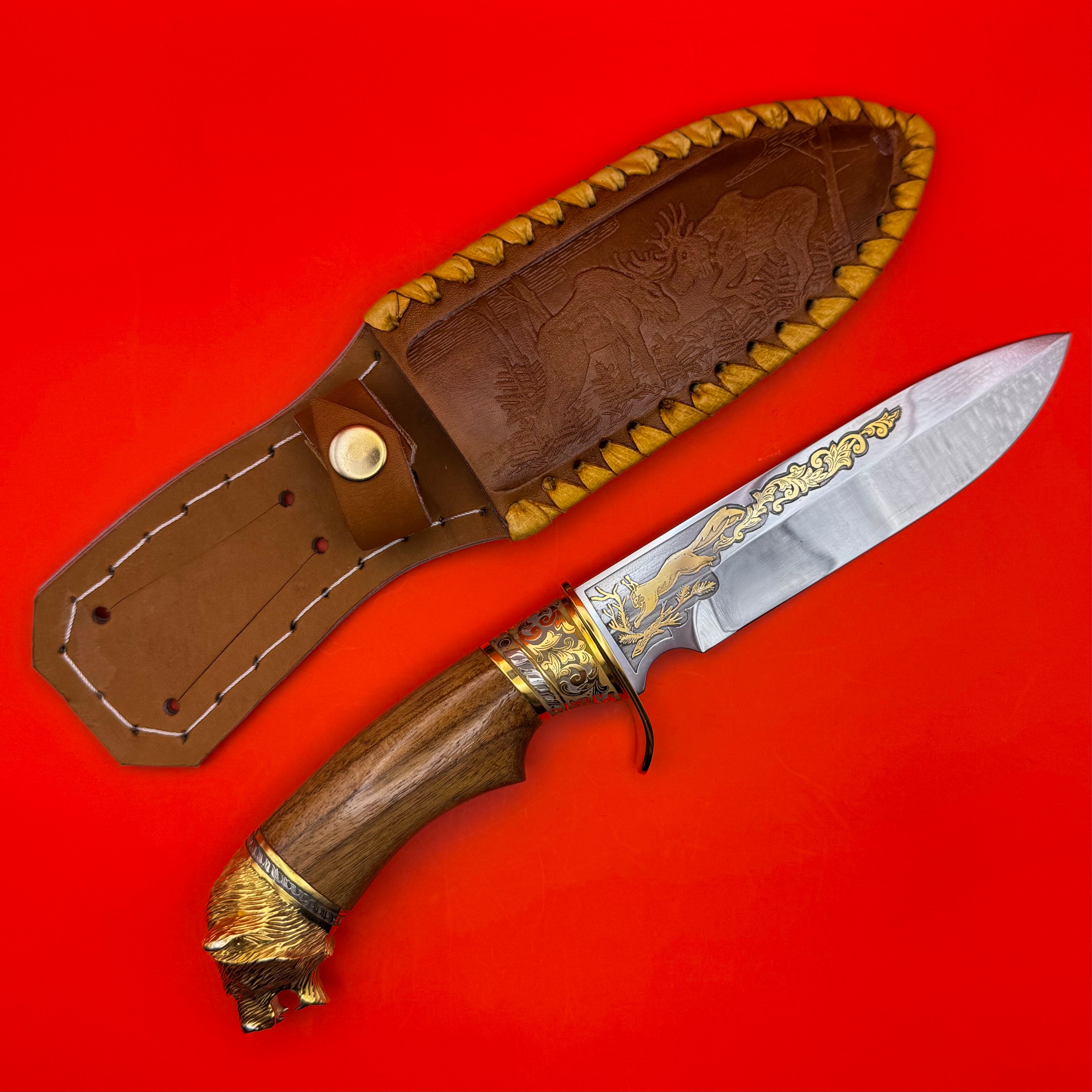 Handcrafted Russian hunting knife with sculpted bear pommel, gold detailing, and engraved leather sheath