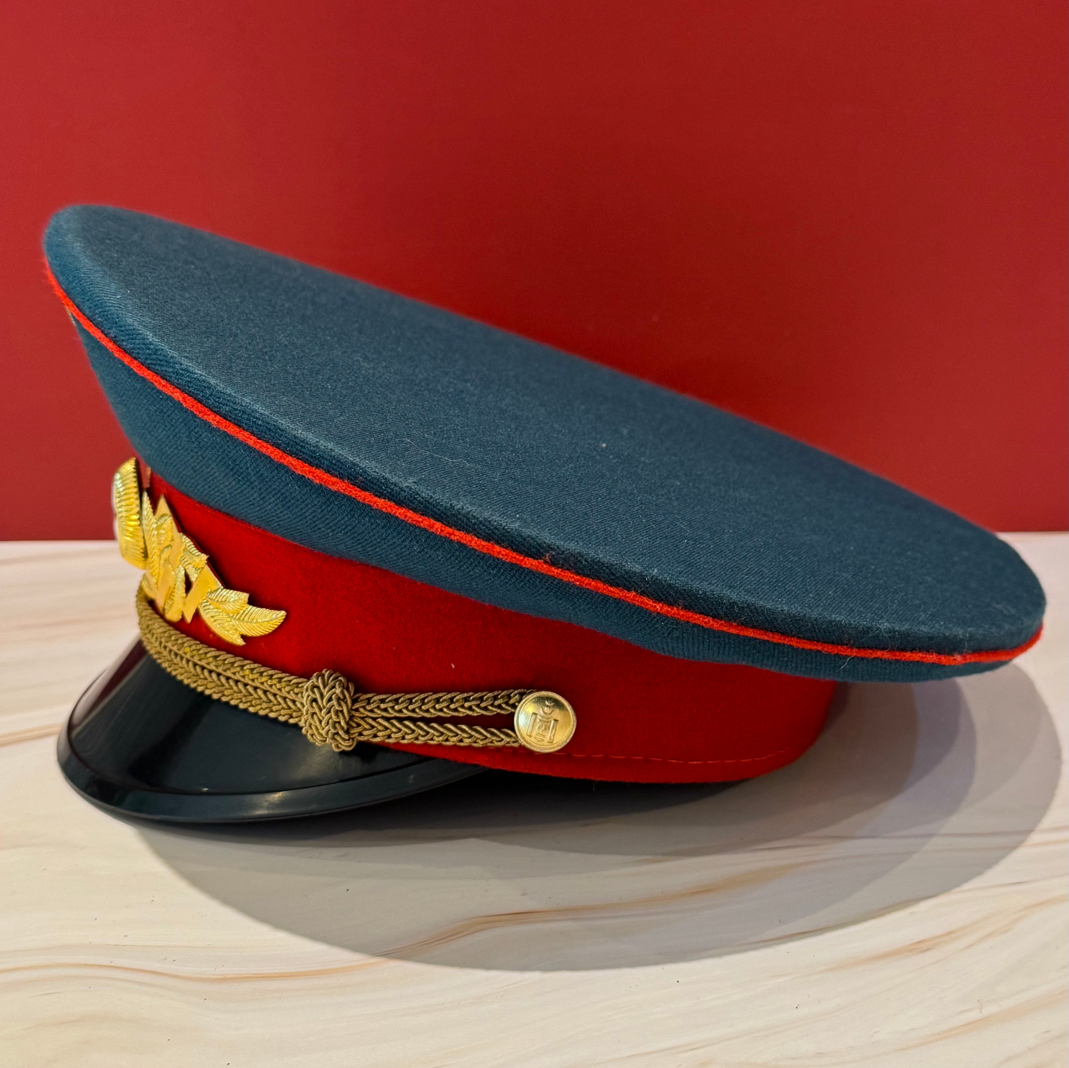 Cold War-era Mongolian military parade cap with blue crown, crimson band, and USSR-inspired parade design