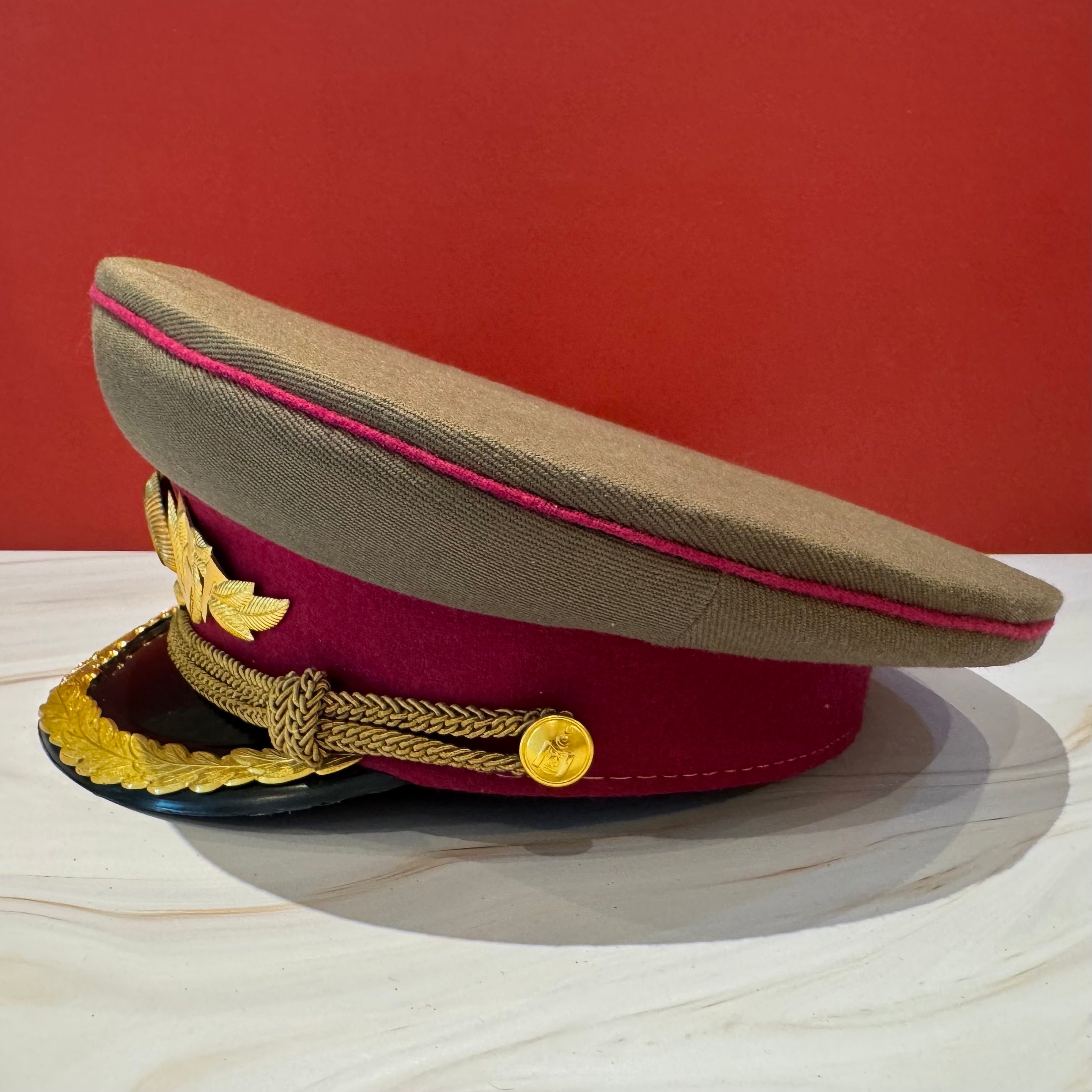 Side view of 1960s Mongolian KGB spy officer cap featuring USSR-inspired style and leather visor