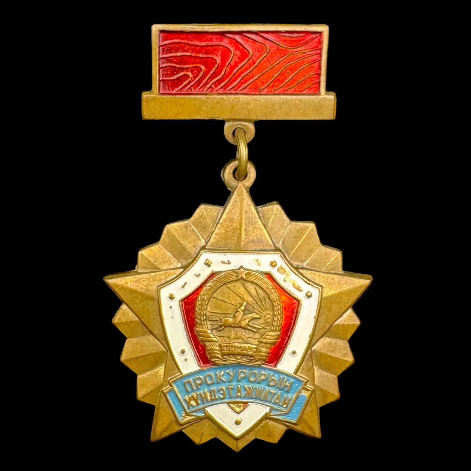 Gold medal with red and blue elements on a black background