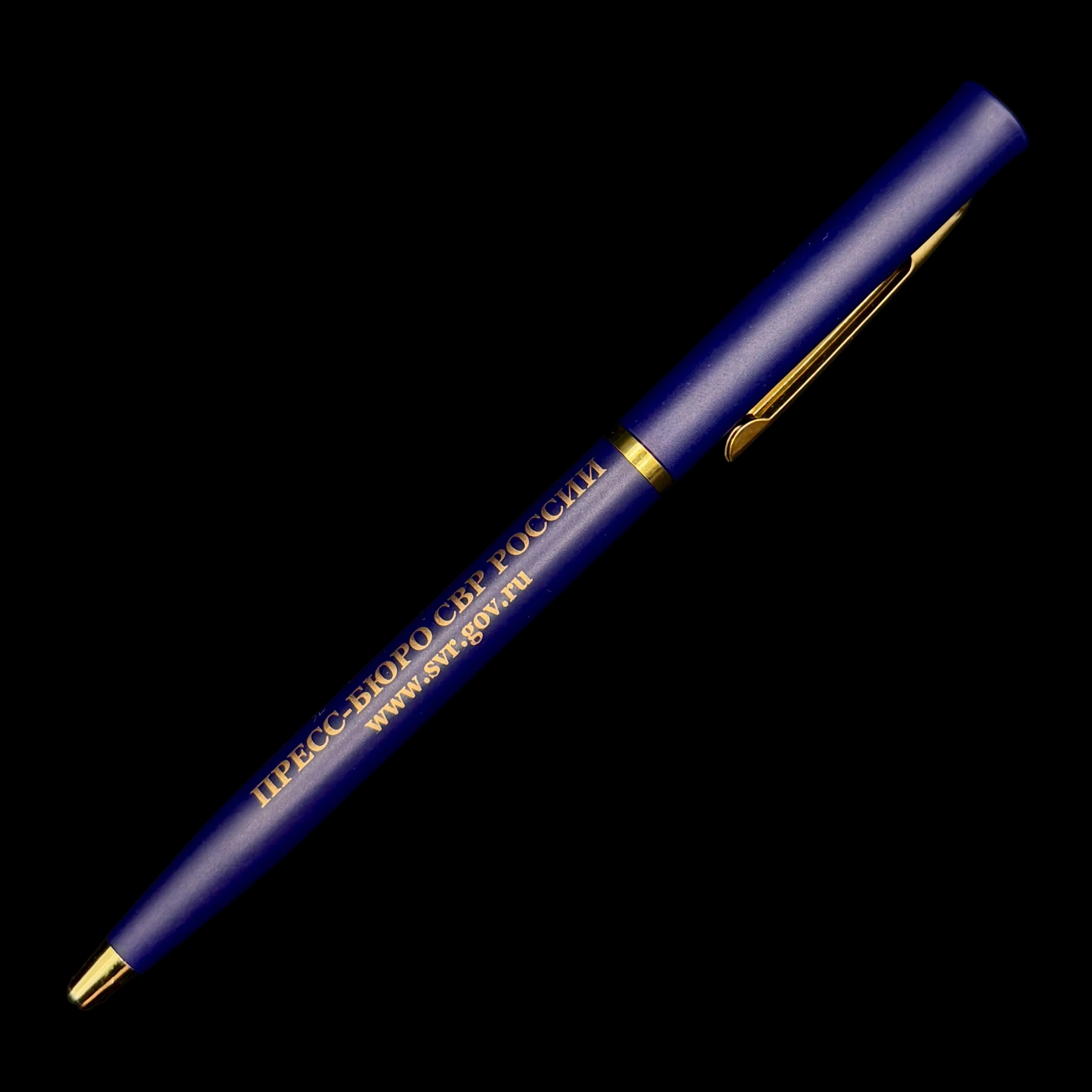 Blue pen with gold accents on a black background