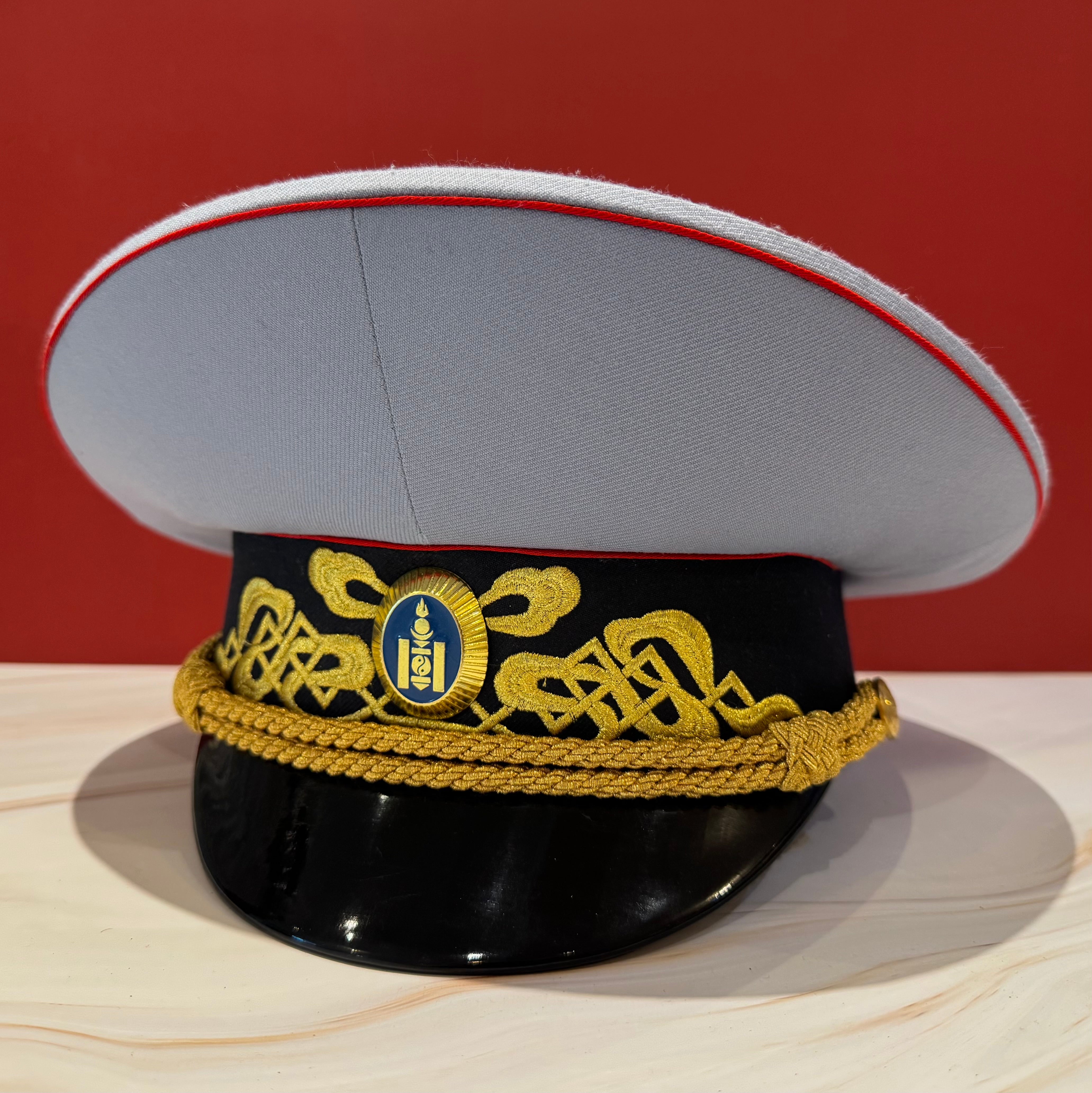 New with tags Mongolian Army general rank parade visor cap with white crown, red piping, and gold embroidered braid across black band. Represents highest parade standard within modern Mongolian Armed Forces, ideal for ceremonial wear collectors.