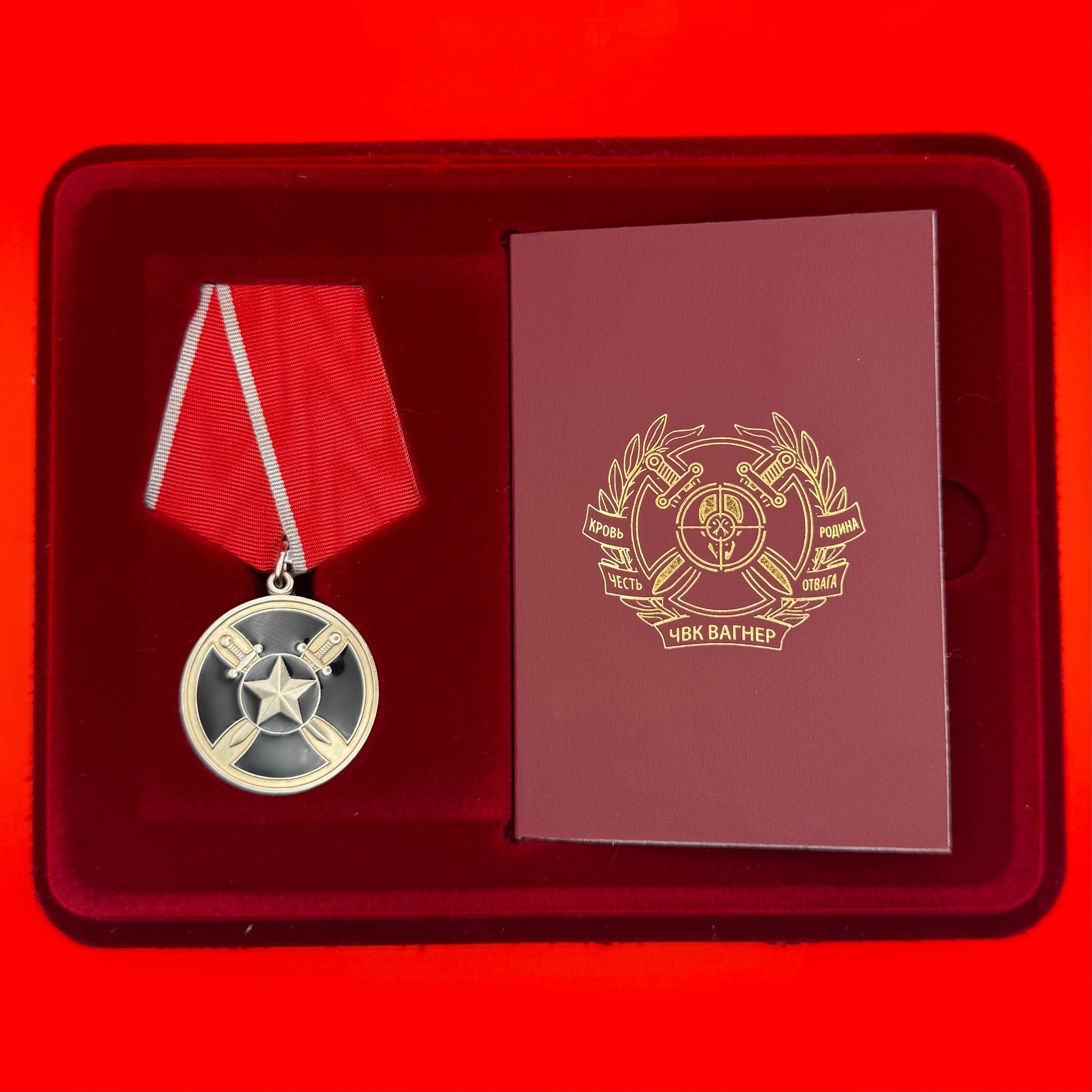 PMC Wagner For Assistance Medal with red ribbon, original award document, and presentation box