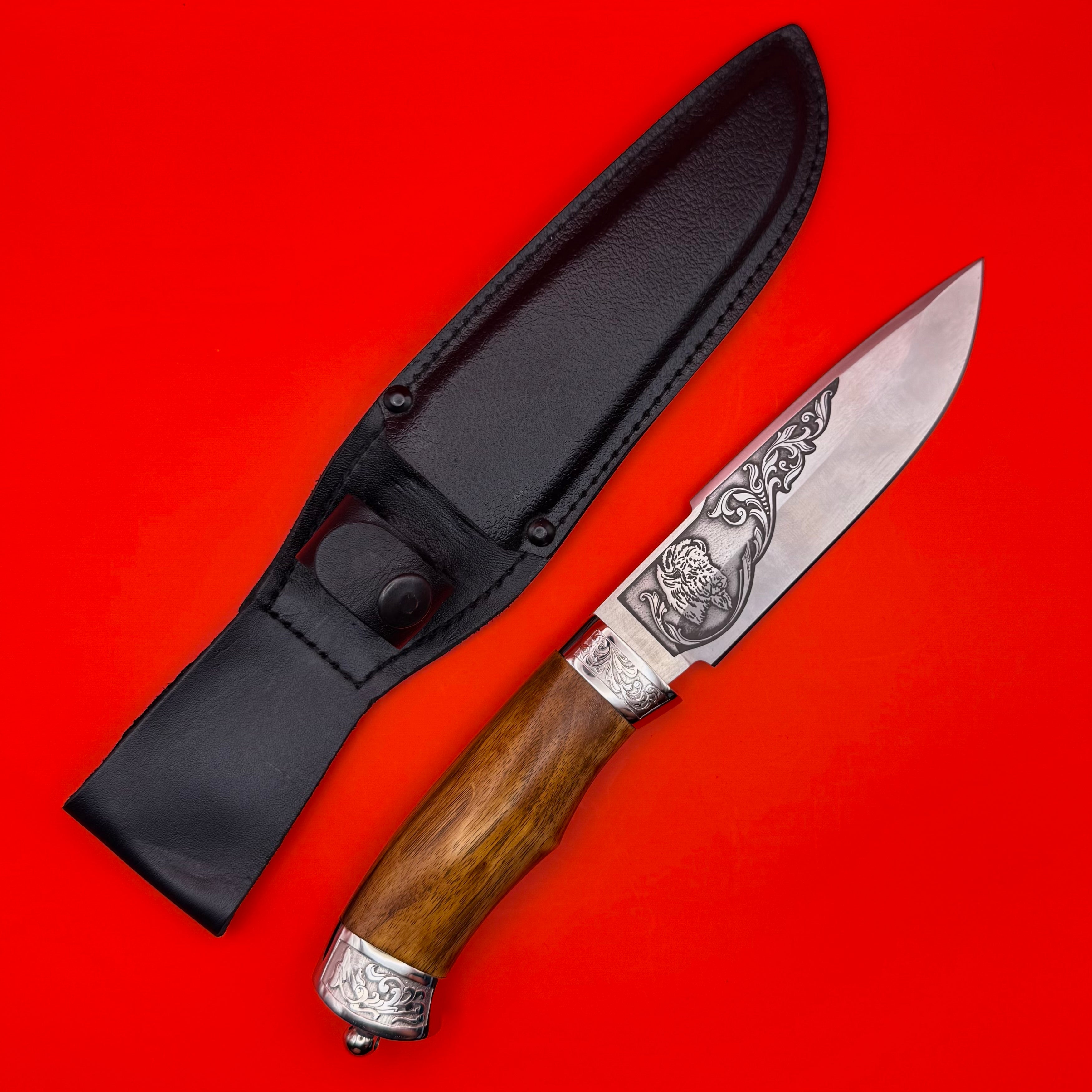 Handcrafted Russian Zlatko hunting knife featuring a bison engraving on the stainless steel blade. The knife has a polished hardwood handle with silver-tone fittings and intricate detailing. Comes with a premium leather sheath and original box, making it a perfect gift or collectible for knife enthusiasts and outdoor adventurers.